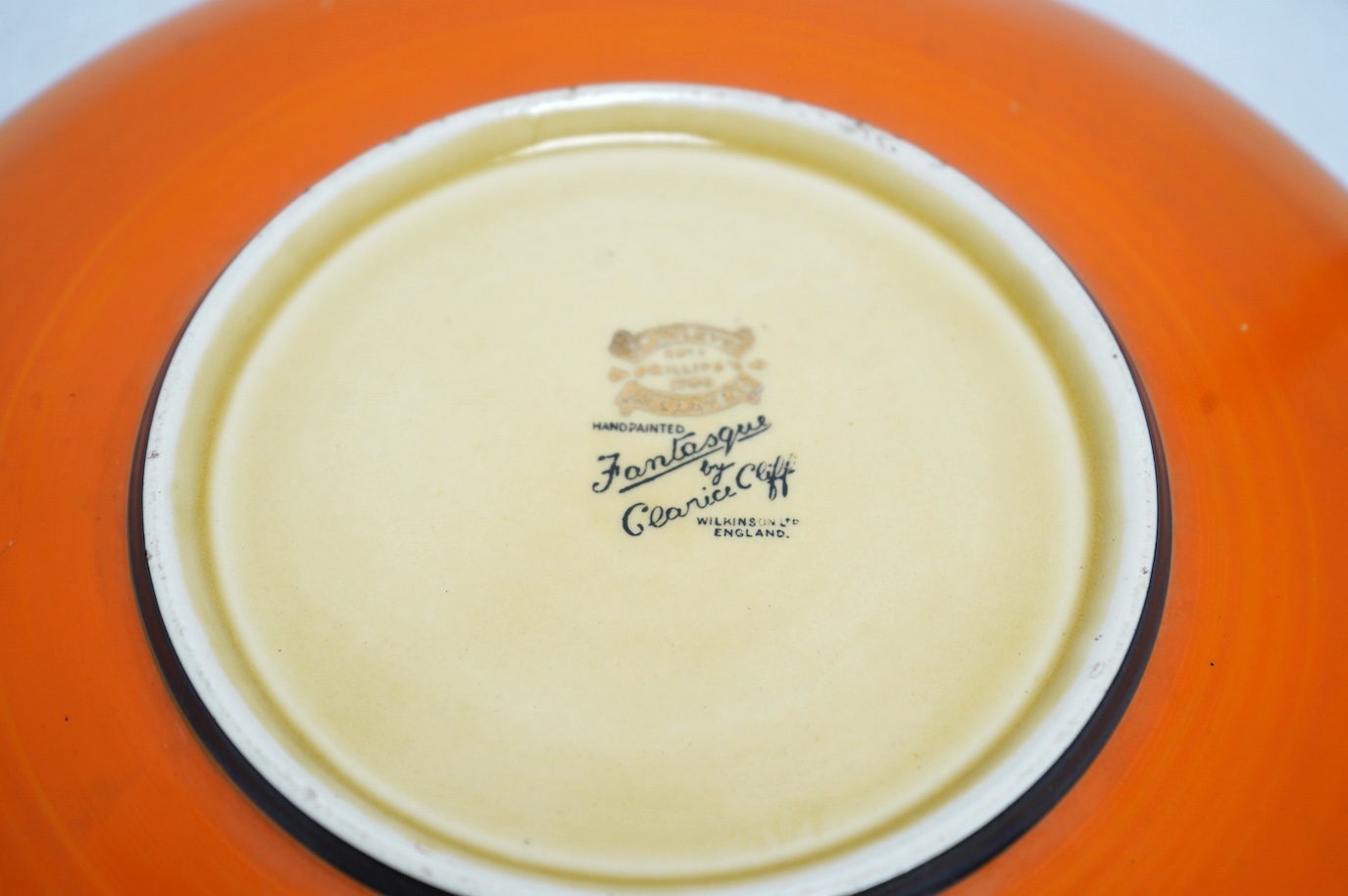 A Clarice Cliff Fantasque shallow dish, 24cm in diameter. Condition - fair